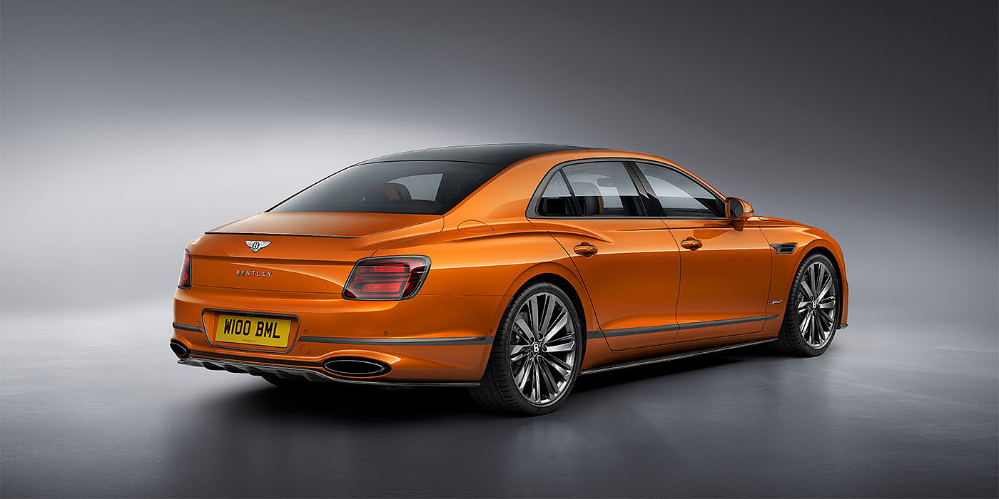 Bentley Polanco Bentley Flying Spur Speed in Orange Flame colour rear view, featuring Bentley insignia and enhanced exhaust muffler.