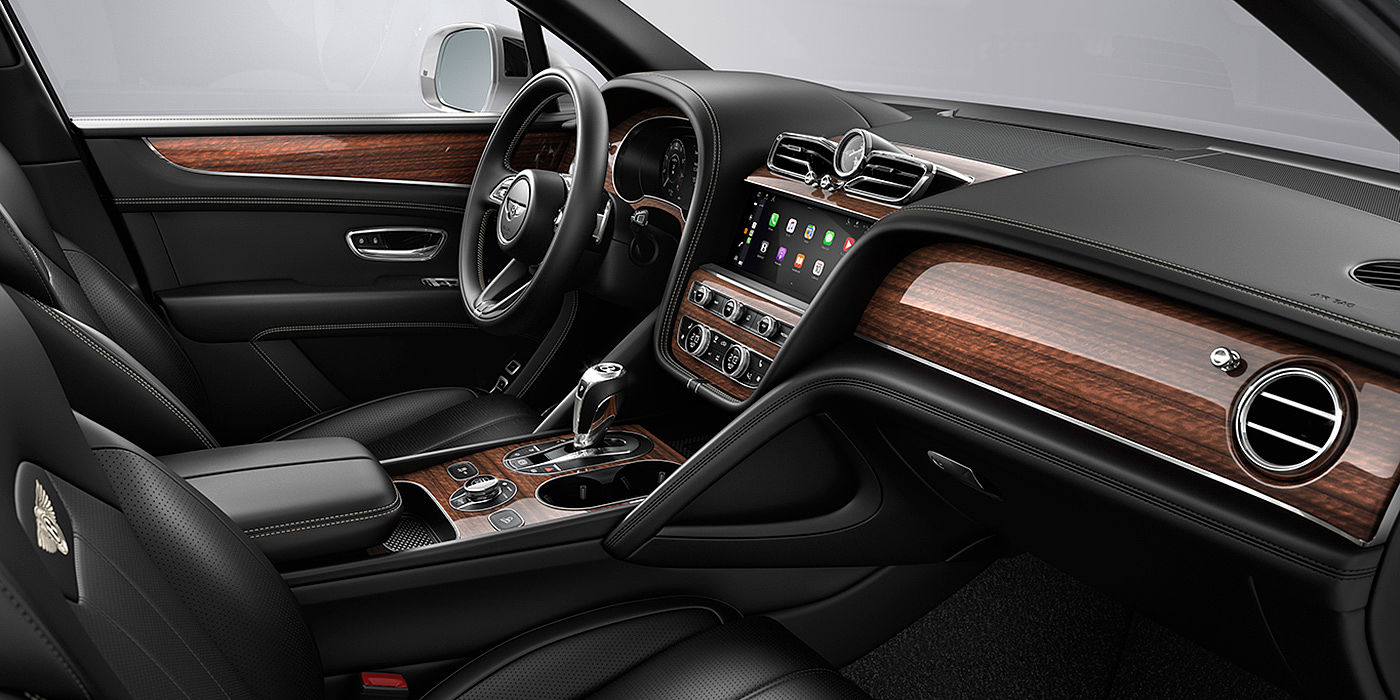 Bentley Polanco Bentley Bentayga interior with a Crown Cut Walnut veneer, view from the passenger seat over looking the driver's seat.