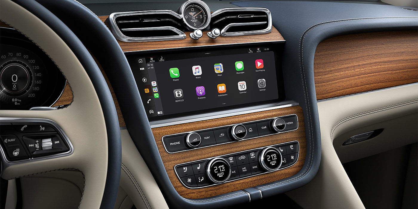 Bentley Polanco Bentley Bentayga EWB Azure dashboard in Open Pore Koa veneer featuring multimedia screen and climate control console.