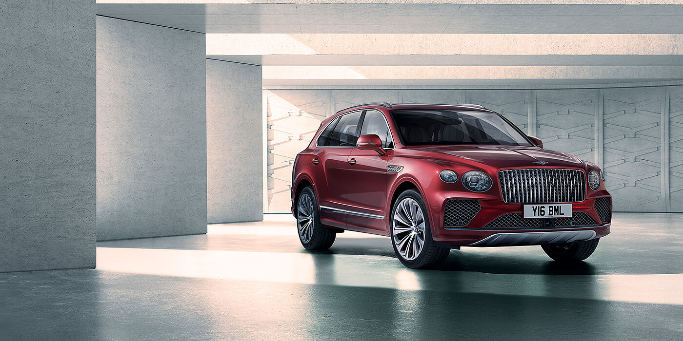 Bentley Polanco Bentley Bentayga Atelier Edition SUV in Rubino Red paint front three quarter against textured concrete wall