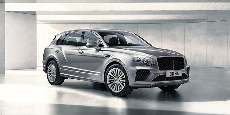 Bentley Polanco Bentley Bentayga Extended Wheelbase SUV front three quarter in Moonbeam paint with a grey background